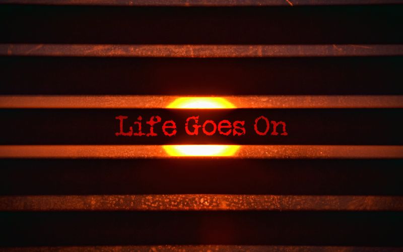 Dark background with the wording 'life-goes-on' part of a feature on grief